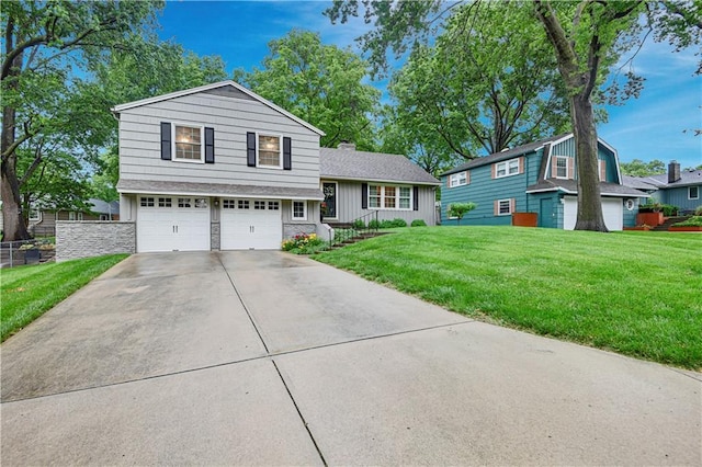 6016 W 85th St, Overland Park, KS 66207 - split level home featuring driveway, an attached garage, stone siding, and a chimney