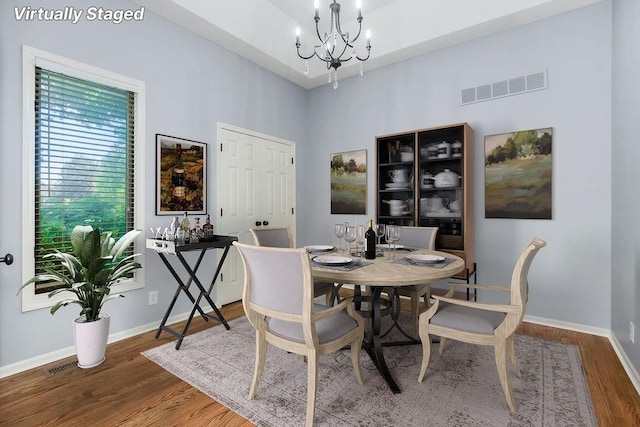 5408 W 153rd St, Leawood, KS 66224 - dining room featuring a chandelier, wood finished floors, baseboards, and a high ceiling