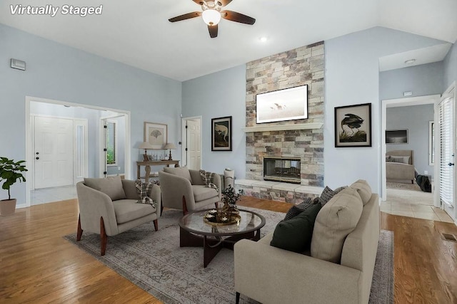 5408 W 153rd St, Leawood, KS 66224 - living area with ceiling fan, wood finished floors, a stone fireplace, and vaulted ceiling
