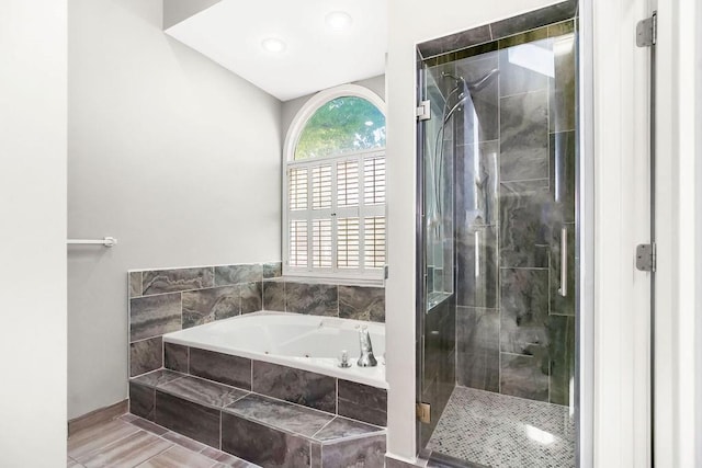 5408 W 153rd St, Leawood, KS 66224 - bathroom featuring a tub with jets, a stall shower, and baseboards