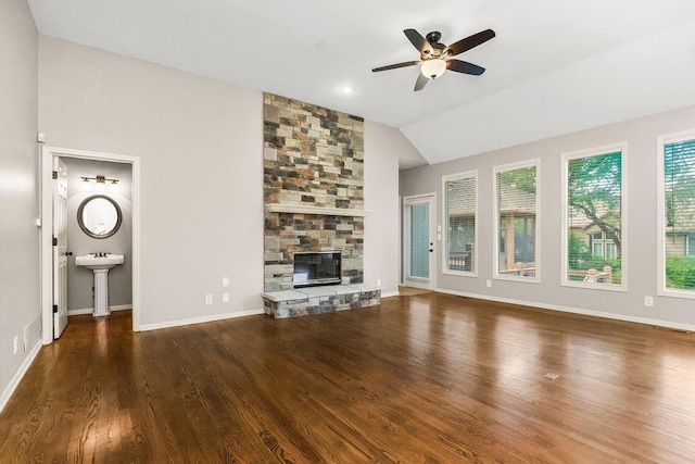 5408 W 153rd St, Leawood, KS 66224 - unfurnished living room with wood finished floors, a ceiling fan, vaulted ceiling, a stone fireplace, and baseboards