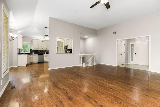 5408 W 153rd St, Leawood, KS 66224 - unfurnished living room with ceiling fan, dark wood finished floors, and baseboards