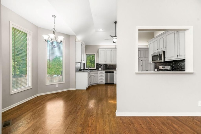 5408 W 153rd St, Leawood, KS 66224 - kitchen featuring appliances with stainless steel finishes, tasteful backsplash, a chandelier, and baseboards