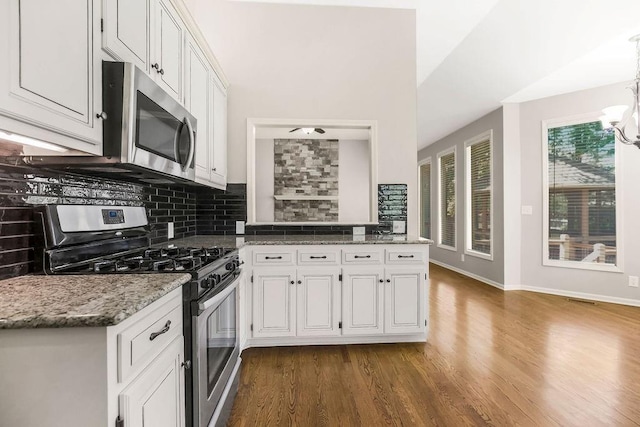 5408 W 153rd St, Leawood, KS 66224 - kitchen with stainless steel appliances, backsplash, dark wood-style floors, and a chandelier