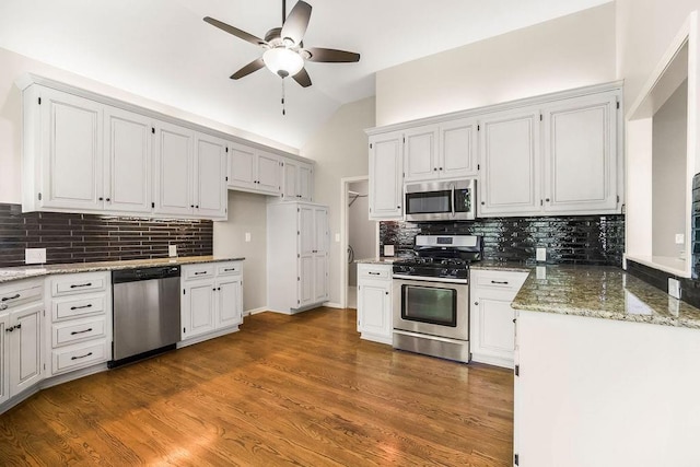5408 W 153rd St, Leawood, KS 66224 - kitchen with appliances with stainless steel finishes, backsplash, ceiling fan, lofted ceiling, and light stone counters