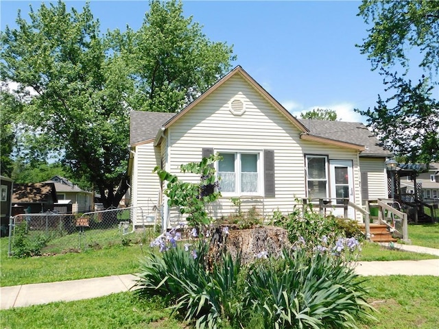 213 W 5th St, Wellsville, KS 66092 - view of front facade featuring roof with shingles