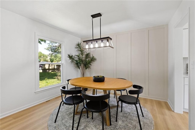 9501 Glenwood St, Overland Park, KS 66212 - dining area with light wood-style floors, plenty of natural light, baseboards, and a decorative wall