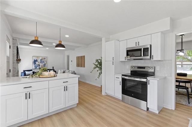9501 Glenwood St, Overland Park, KS 66212 - kitchen with appliances with stainless steel finishes, light wood-type flooring, open floor plan, light countertops, and recessed lighting