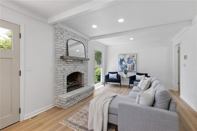 9501 Glenwood St, Overland Park, KS 66212 - living area with wood finished floors, beam ceiling, a brick fireplace, recessed lighting, and baseboards