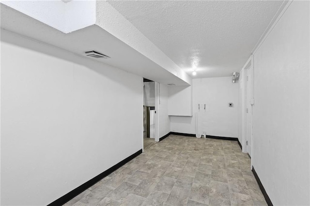 9501 Glenwood St, Overland Park, KS 66212 - finished below grade area with baseboards, a textured ceiling, and stone finish flooring