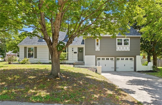 9501 Glenwood St, Overland Park, KS 66212 - tri-level home featuring a garage, driveway, and brick siding