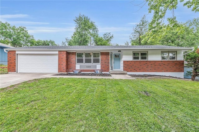 5005 S Grand Ave, Independence, MO 64055 - view of front of home featuring brick siding, concrete driveway, a garage, and a front lawn