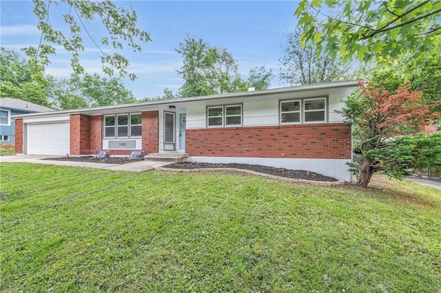 5005 S Grand Ave, Independence, MO 64055 - view of front of property with brick siding, a front lawn, and an attached garage