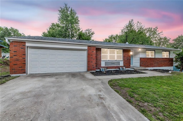 5005 S Grand Ave, Independence, MO 64055 - ranch-style house featuring brick siding, driveway, and an attached garage
