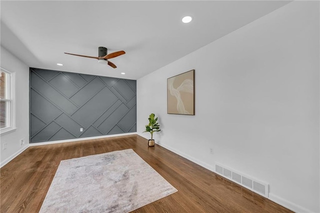 5005 S Grand Ave, Independence, MO 64055 - spare room featuring baseboards, ceiling fan, wood finished floors, recessed lighting, and an accent wall