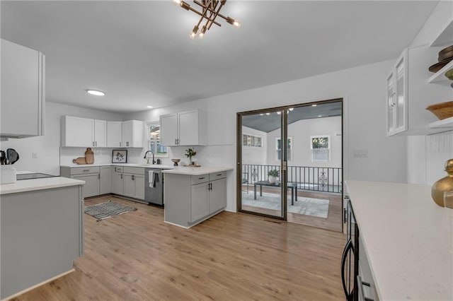 5005 S Grand Ave, Independence, MO 64055 - kitchen featuring open shelves, light wood-style flooring, plenty of natural light, tasteful backsplash, and recessed lighting