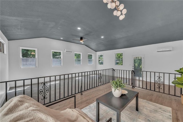 5005 S Grand Ave, Independence, MO 64055 - living room featuring lofted ceiling, an AC wall unit, wood finished floors, a ceiling fan, and recessed lighting