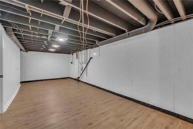 5005 S Grand Ave, Independence, MO 64055 - unfinished basement featuring wood finished floors and baseboards