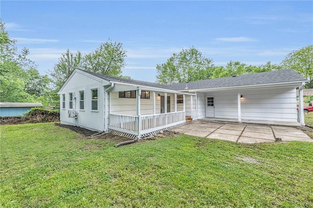 5005 S Grand Ave, Independence, MO 64055 - view of front facade with a front yard, covered porch, and a patio area