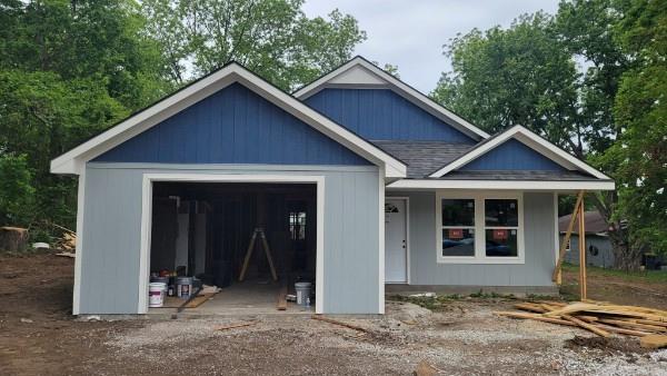 106 S Sallie St, Mayview, MO 64071 - view of front facade featuring an attached garage and roof with shingles