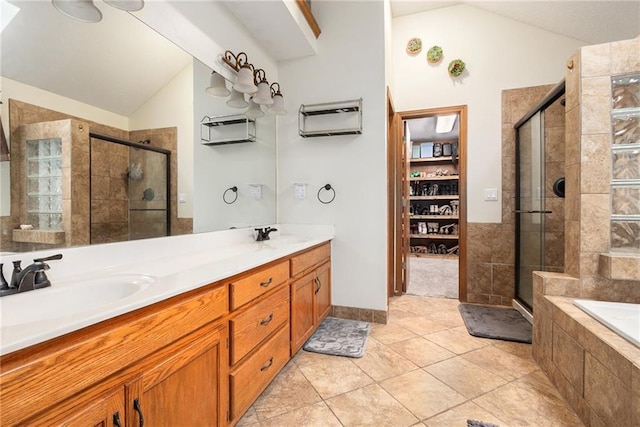 7504 N Palmer Ave, Kansas City, MO 64158 - full bathroom with lofted ceiling, a stall shower, double vanity, a bath, and tile patterned floors