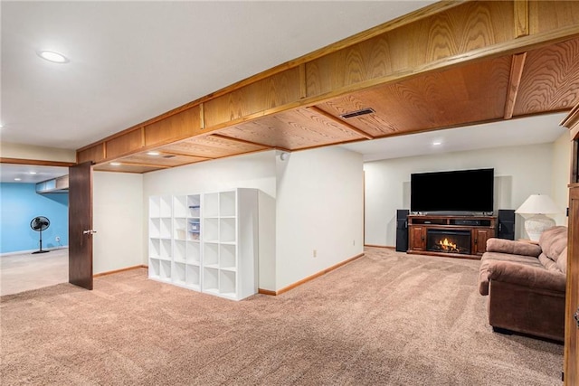 7504 N Palmer Ave, Kansas City, MO 64158 - living area with carpet, baseboards, recessed lighting, and a warm lit fireplace