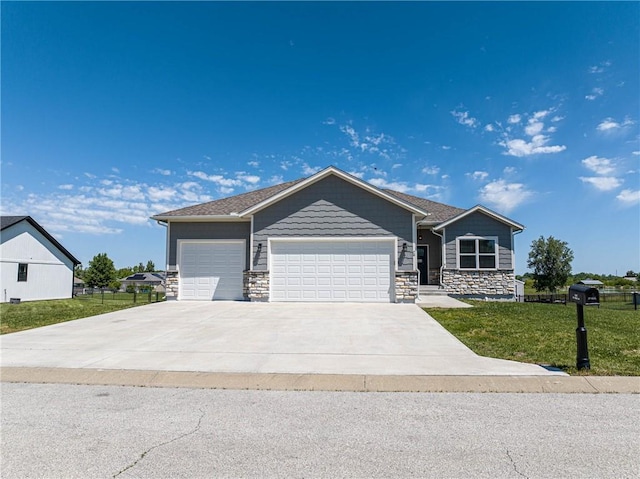 76 Casper St, Garden City, MO 64747 - view of front of house with stone siding, an attached garage, a front lawn, and concrete driveway