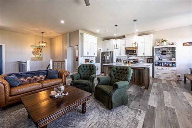 76 Casper St, Garden City, MO 64747 - living area with dark wood-style floors, a chandelier, and recessed lighting