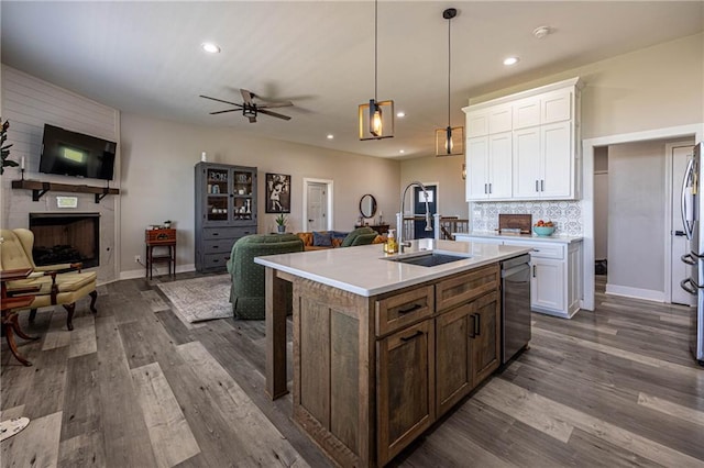76 Casper St, Garden City, MO 64747 - kitchen with a sink, open floor plan, ceiling fan, stainless steel dishwasher, and dark wood-style floors