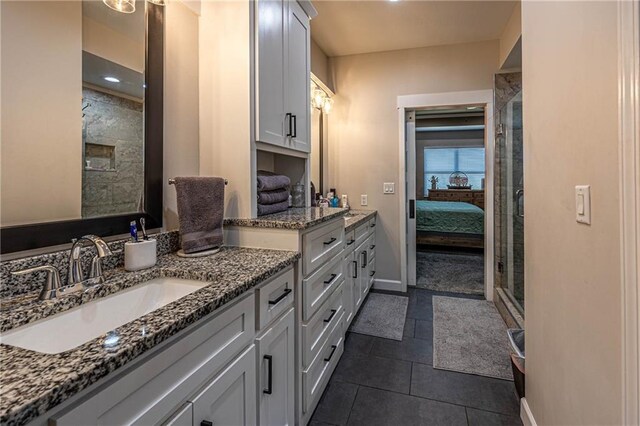 76 Casper St, Garden City, MO 64747 - ensuite bathroom with vanity, baseboards, tile patterned flooring, and a shower with shower door