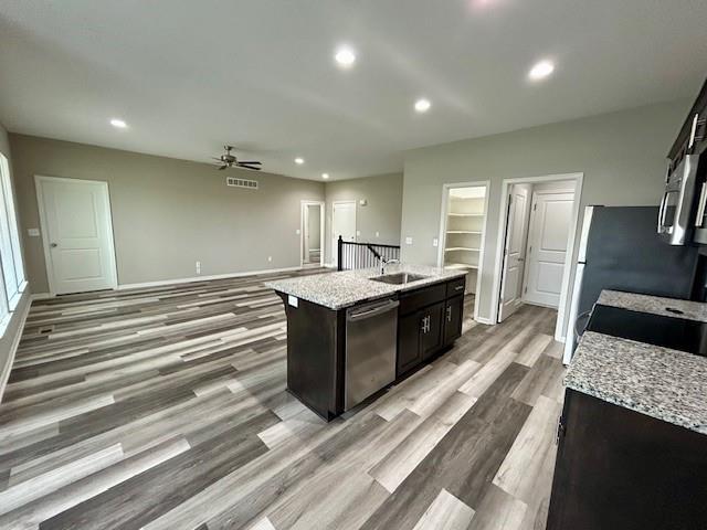 10204 Siena Dr, Peculiar, MO 64078 - kitchen with dishwasher, ceiling fan, a sink, light wood-style floors, and recessed lighting