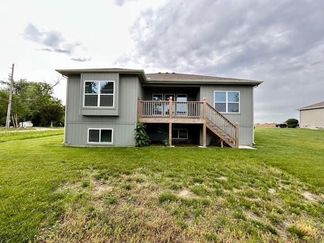 10204 Siena Dr, Peculiar, MO 64078 - rear view of property featuring stairway, a wooden deck, and a lawn