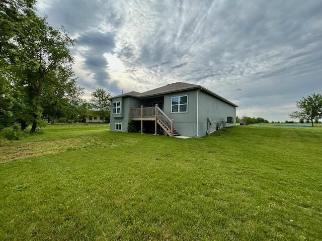 10204 Siena Dr, Peculiar, MO 64078 - rear view of house featuring stairway, a yard, and a deck
