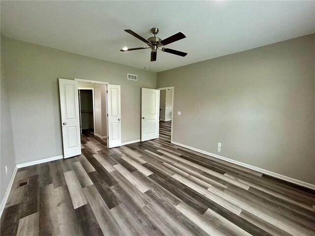 10204 Siena Dr, Peculiar, MO 64078 - unfurnished bedroom with baseboards, dark wood-style flooring, and ceiling fan