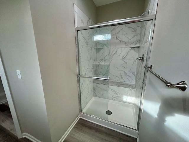 10204 Siena Dr, Peculiar, MO 64078 - full bathroom with a shower stall, wood finished floors, and baseboards