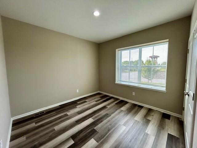 10204 Siena Dr, Peculiar, MO 64078 - empty room with dark wood-style flooring, recessed lighting, and baseboards