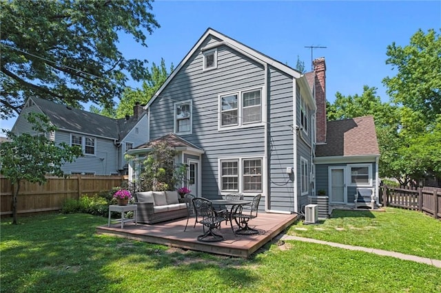 611 E 64th Ter, Kansas City, MO 64131 - back of house featuring a fenced backyard, a wooden deck, and a chimney