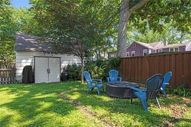 611 E 64th Ter, Kansas City, MO 64131 - fenced backyard featuring an outdoor fire pit and a storage shed