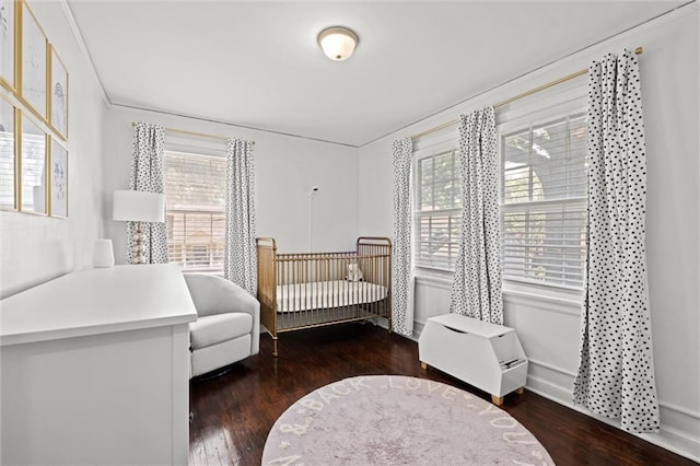 611 E 64th Ter, Kansas City, MO 64131 - bedroom featuring wood finished floors and a crib