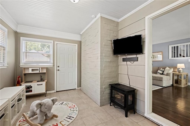 611 E 64th Ter, Kansas City, MO 64131 - entryway with a wood stove, ornamental molding, and light tile patterned flooring
