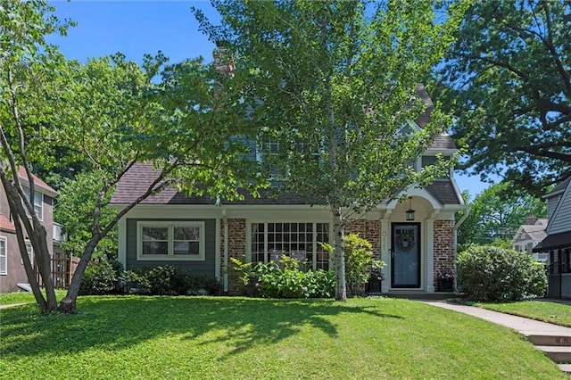 611 E 64th Ter, Kansas City, MO 64131 - obstructed view of property with a front yard and brick siding