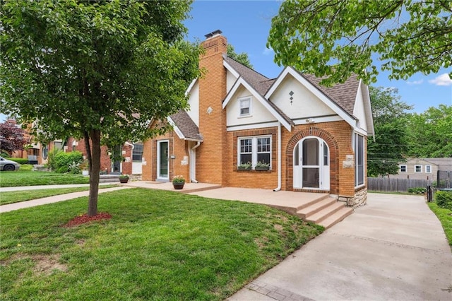 6661 Locust St, Kansas City, MO 64131 - view of front of property with a chimney, brick siding, and a shingled roof