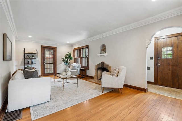 6661 Locust St, Kansas City, MO 64131 - living area featuring plenty of natural light, light wood finished floors, arched walkways, ornamental molding, and recessed lighting