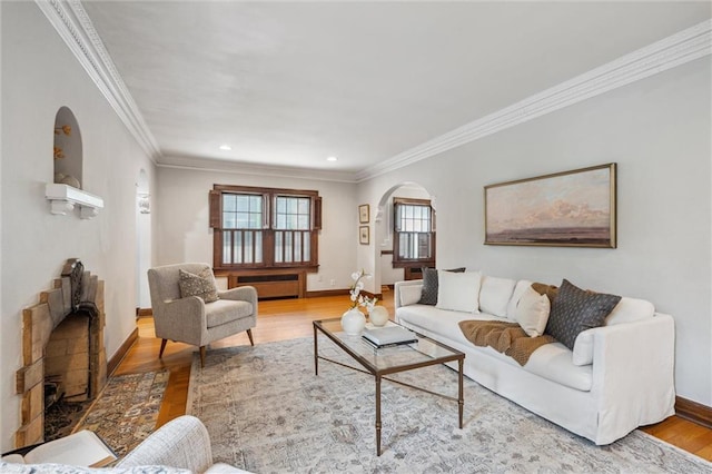 6661 Locust St, Kansas City, MO 64131 - living area with arched walkways, healthy amount of natural light, wood finished floors, crown molding, and recessed lighting