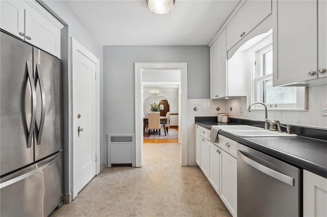 6661 Locust St, Kansas City, MO 64131 - kitchen with stainless steel appliances, a sink, light flooring, and dark countertops