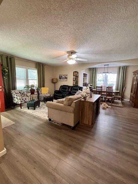 217 5th St, Burlington, KS 66839 - living room featuring dark wood-style floors, a textured ceiling, and ceiling fan