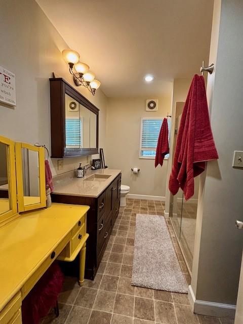 217 5th St, Burlington, KS 66839 - full bathroom featuring vanity, toilet, a shower stall, tile patterned floors, and baseboards