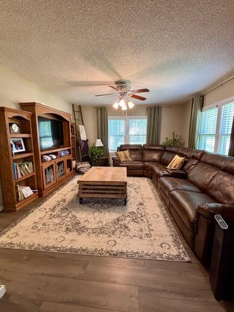 217 5th St, Burlington, KS 66839 - living room with ceiling fan, hardwood / wood-style floors, and a textured ceiling