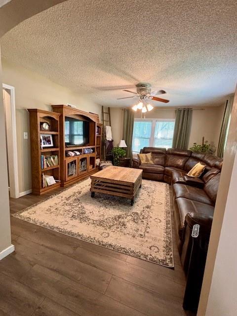 217 5th St, Burlington, KS 66839 - living area featuring ceiling fan, wood finished floors, a textured ceiling, and baseboards