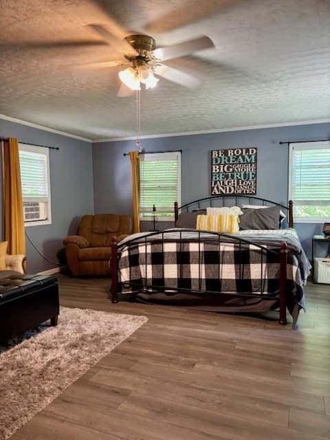 217 5th St, Burlington, KS 66839 - bedroom featuring multiple windows, wood finished floors, crown molding, and a textured ceiling